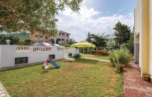 a backyard with a playground with a slide at Apartmani Jadra in Stara Novalja