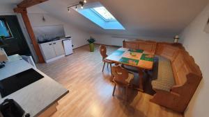 a living room with a table and a kitchen at Ossiachersee Apartments in Steindorf am Ossiacher See