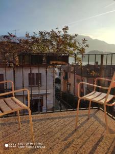 a couple of chairs sitting on top of a balcony at Azzano Holidays B&B in Mezzegra