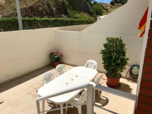 a white table and chairs on a balcony at Casa AuroraBikinis in Fuengirola