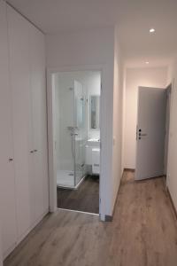 ein leeres Zimmer mit einem Bad mit einer Dusche und einem Spiegel in der Unterkunft Coimbra Monumentais B&B in Coimbra