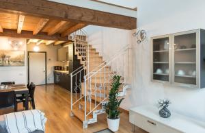 a living room with a staircase and a dining room at Comfy loft on Hlavna in Košice