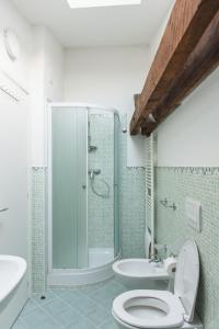 a bathroom with a shower and a toilet and a sink at Comfy loft on Hlavna in Košice +14 photos
