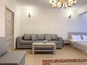 a living room with a couch and a table at Brand new comfortable apartments in Sevan city in Sevan