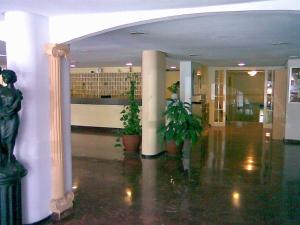 a lobby with columns and plants in a building at Sol y relax, AGUILA in Benalmádena +38 photos
