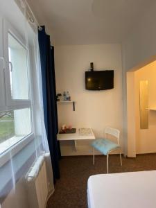 a room with a bed and a table and a window at Pastel Guest Rooms in Warsaw +23 photos