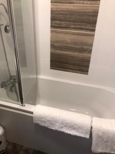 a bathroom with a bath tub with a towel on it at 81 The Heathers, Aviemore Holiday Park , Dalfaber rd Aviemore PH22 1PX in Aviemore