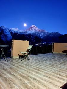 a balcony with a view of a snow covered mountain at Nikolo Inn in Stepantsminda