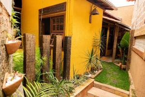 a yellow house with plants in front of it at Chalé Diamantina in Diamantina