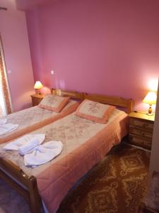 a bedroom with two beds with towels on them at Epikoureios Apollon in Andritsaina