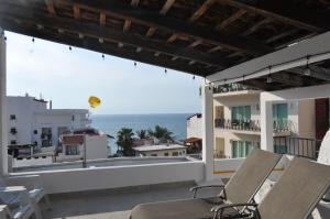 a balcony with chairs and a view of the ocean at Petit Hotel Pilitas in Puerto Vallarta