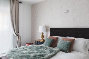 A bed or beds in a room at La Suite al Vaticano