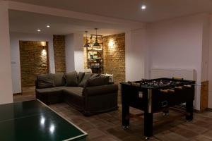 a living room with a couch and a table with chess at Polonia in Polanica-Zdrój