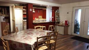 a kitchen and dining room with a table and chairs at Entre-parenthèses in Vagney