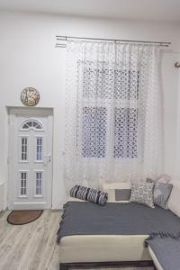a bedroom with a bed and a window and a door at Nina in Banja Koviljača