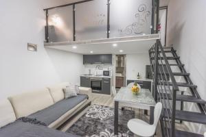 a living room with a staircase leading up to a loft at Nina in Banja Koviljača +24 photos