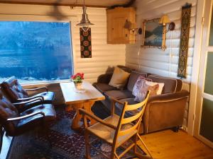a living room with a couch and a table at Hytte ved Preikestolen in Forsand
