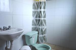 a bathroom with a toilet and a sink at Quilotoa Green Lake in Quilotoa