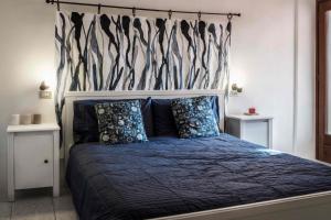 a bedroom with a bed with a blue comforter at Hiking Escape Parzanica in Parzanica