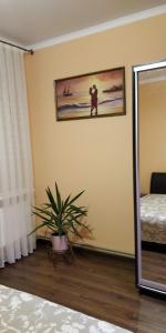 a bedroom with a picture of a couple on the wall at Apartment near University in Chernivtsi