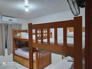 two bunk beds in a room with white walls at Hostel Lençóis Park in Barreirinhas
