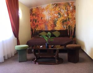 a living room with a couch and a painting at ТерКон-Тур in Bukovel