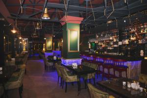 a restaurant with tables and chairs and a bar at Berrak Otel in Salihli