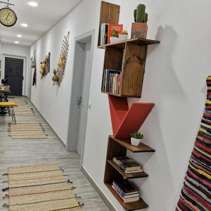 a hallway with wooden shelves on the wall at Casinhas do Canário in Montoito