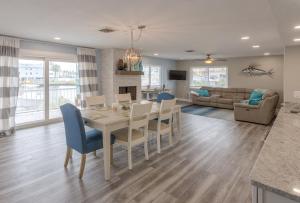a dining room and living room with a table and chairs at Waterfront & Pool Star5Vacations in St Pete Beach