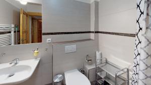 a bathroom with a sink and a toilet and a mirror at Apartmány Ester in Rokytnice nad Jizerou