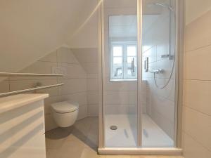 a bathroom with a shower and a toilet at Ferienwohnung Gül Waanang in Nebel +22 photos