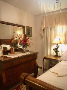 a bedroom with a bed and a table with a lamp at WINNIE'S BED & BREAKFAST in Lawrenceburg