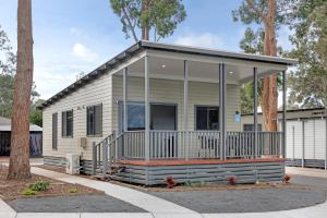 a mobile home with a screened in porch at Discovery Parks - Forster in Tuncurry