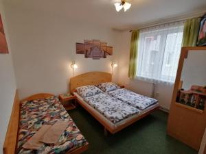 Postel nebo postele na pokoji v ubytování Penzión Poľana