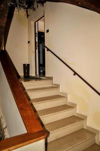 a staircase in a house with wooden railings at Appartamento Gubbio Vacanze in Gubbio