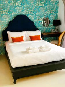 a bedroom with a bed with two towels on it at Villa Think Of Home in Khao Lak