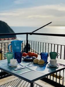 einen Tisch mit Teller mit Speisen auf dem Balkon in der Unterkunft Al castello in Riomaggiore