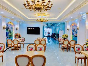 a banquet hall with tables and chairs and a flat screen tv at HaTa Hotel in Quy Nhon