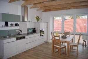 a kitchen with a table and a dining room at Friedeburga in Friedeburg