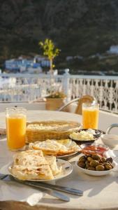 a table topped with plates of food and orange juice at Maison d'hôte Bousaid in Chefchaouene