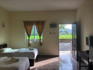 Postel nebo postele na pokoji v ubytování DVilla Guesthouse Langkawi