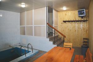 a room with a table and a sink and a staircase at Хостел на Баварии in Kharkiv