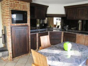 a kitchen with a table with a green apple on it at Vakantiewoning Upstairzzz in Kortessem