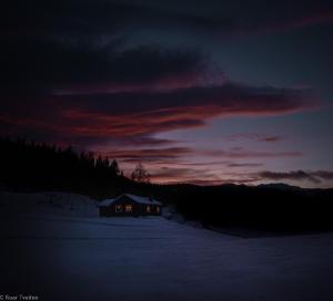 a house in the snow with a sunset in the background at Tuddal Hyttegrend, GAMLESTUGU, Telemark in Tuddal