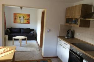 a kitchen and a living room with a couch at Urlaub mit Blick auf Schiltachs Fachwerkhäuser in Schiltach