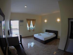 Postel nebo postele na pokoji v ubytování DVilla Guesthouse Langkawi