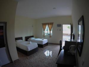 Postel nebo postele na pokoji v ubytování DVilla Guesthouse Langkawi