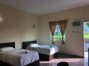 Postel nebo postele na pokoji v ubytování DVilla Guesthouse Langkawi
