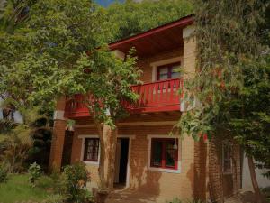 ein Haus mit einem roten Balkon darüber in der Unterkunft NY Telomiova in Antananarivo