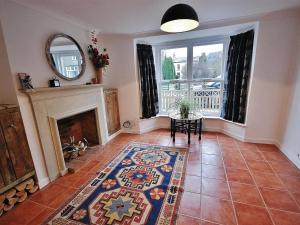 a living room with a fireplace and a mirror at EasyRest Spalding - 5 Beds & Free Parking - Central & Quiet Location - 3rd Bedroom Optional - Entire Spacious House in Spalding